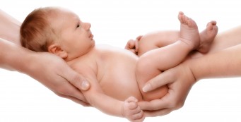 Father and Mother holding newborn after DNA Test