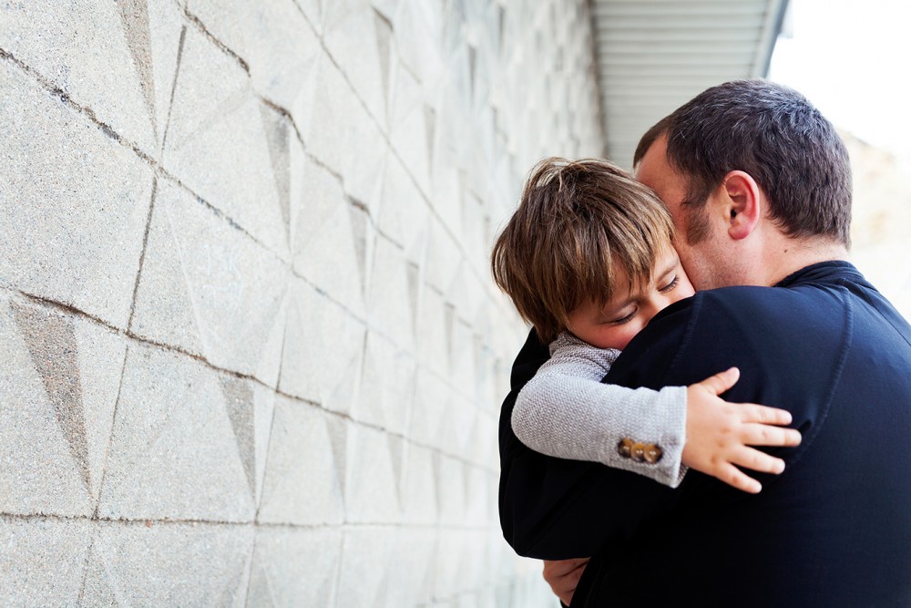 FATHER HUGGING SON AFTER A PATERNITY TEST